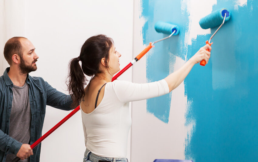 young couple painting the wall 7WH22K4